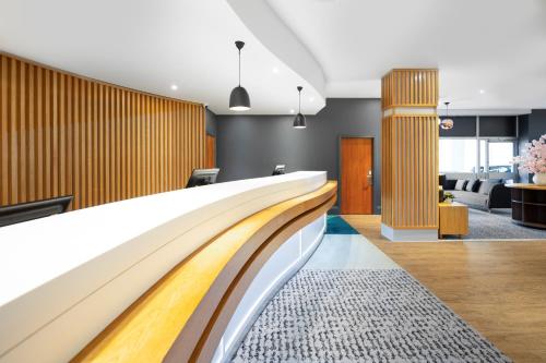 an escalator in a hotel lobby with a waiting room at Holiday Inn Leicester City by IHG in Leicester