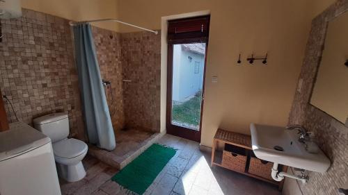 a bathroom with a toilet and a sink and a shower at Sunshine Villa Fonyódliget in Fonyód
