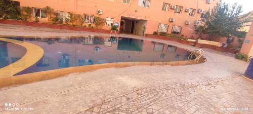 a swimming pool in front of a building at Charmant appartement moderne au cœur de Gueliz, Marrakech Lumineux", Cosy", Bien situé in Marrakech