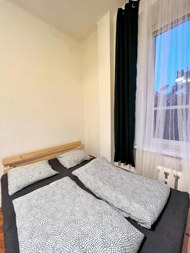 a bedroom with two beds in front of a window at Main Square Rooms in Krakow