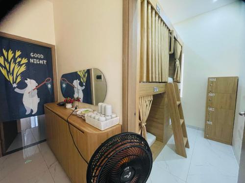 a room with a fan and a dressing room at Basic Guest House Hải Phòng in Hai Phong