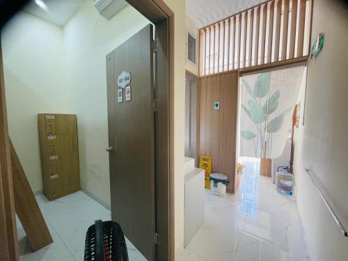 a hallway with a door leading into a room at Basic Guest House Hải Phòng in Hai Phong