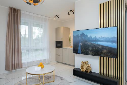 a living room with a large flat screen tv on a wall at Fortune Apartments - River view, Contactless in Tartu
