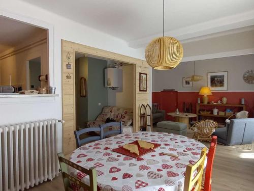 a dining room with a table and a living room at Appartement Villard-de-Lans, 3 pièces, 5 personnes - FR-1-548-19 in Villard-de-Lans