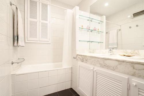 ein weißes Badezimmer mit einer Badewanne und einem Waschbecken in der Unterkunft FANTASTIC apartment in Barcelona in Barcelona