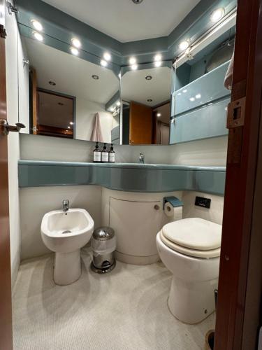 a bathroom with a toilet and a sink and a mirror at YACHT 20Metros in Barcelona