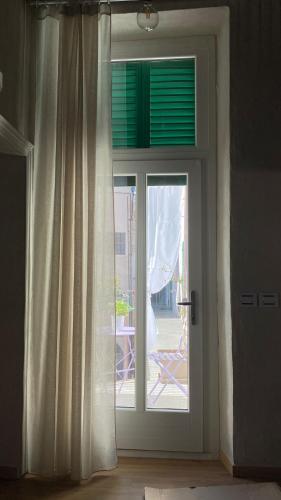 a sliding glass door with a view of a patio at Il Garibaldi in Savigliano