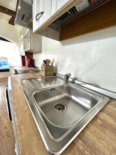 a stainless steel sink in the middle of a kitchen at RESIDENCE ZAR - 2 in Trieste
