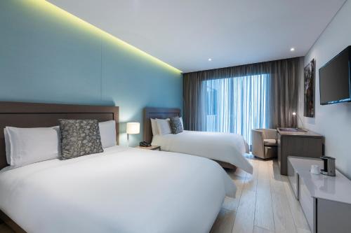 Postel nebo postele na pokoji v ubytování Hotel 100 Luxury Suites by Preferred