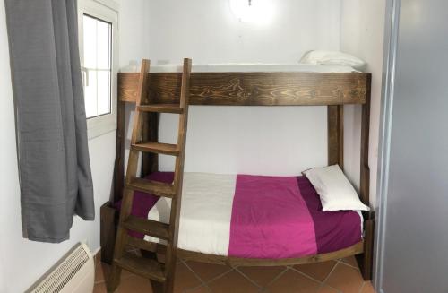 a bunk bed with a ladder in a room at Plaza Andalucia Edificio Dornajo 215 in Sierra Nevada