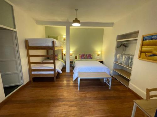 a room with two beds and a bunk bed at Illa B&B in Cusco