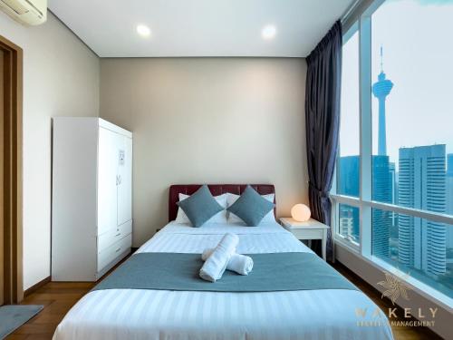 Säng eller sängar i ett rum på Soho Suites KLCC by Wakely Kuala Lumpur