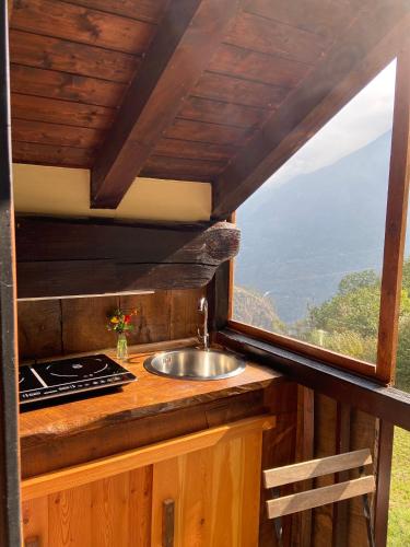 a kitchen with a sink and a window at B&B Marcellina in Bard