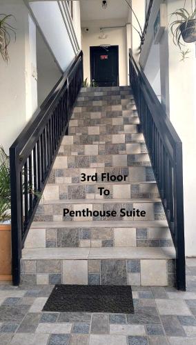 a stairway with a sign that reads end floor to penthouse suite at Trail Bedz Homestay in Baguio