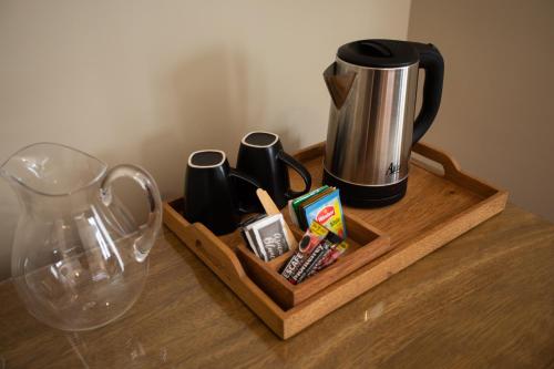 a wooden tray with a coffee pot and cups on a table at Hotel Boutique Rosario Sur in La Paz