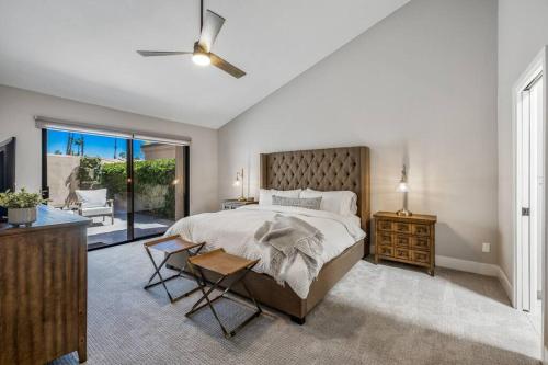 a bedroom with a large bed and a balcony at Beautiful Condo with Mountain & Sunset Views! in Palm Desert