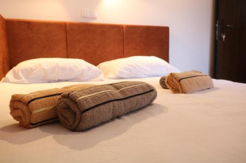 a bedroom with two beds with towels on them at Holiday Home Rajf in Donji Koncovčak