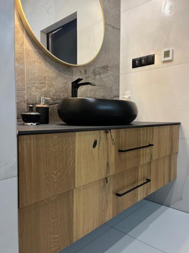 a bathroom with a black sink and a mirror at ROYAL HILL II in Białka Tatrzańska