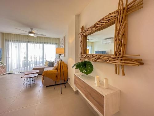 a living room with a mirror and a couch at Fantastic brand new beach condo in Punta Cana