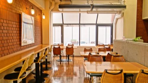 a restaurant with tables and chairs in a room at Morioka New City Hotel in Morioka