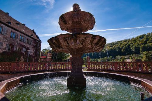 a fountain with a bird sitting on top of it at Gasthaus Klosterhof in Bronnbach