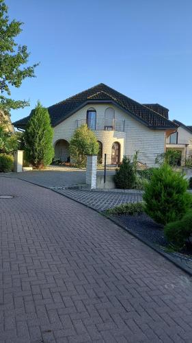 a house with a brick driveway in front of it at Boarding-Haus, Ostercappeln in Ostercappeln