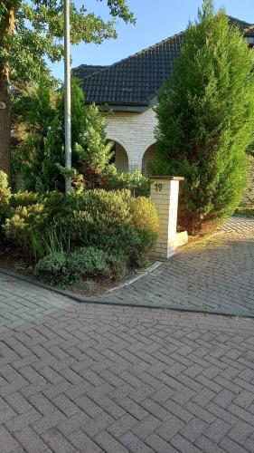 a house with a brick driveway in front of a house at Boarding-Haus, Ostercappeln in Ostercappeln