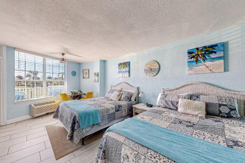 a bedroom with two beds and a window at Right Along the Beach in Daytona Beach