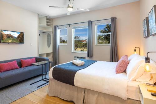 a bedroom with a bed and a couch at Bloom Hideaway - Mins to Las Olas & Beach in Fort Lauderdale