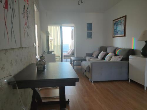 a living room with a couch and a table at Mirador de Calpe. Apartment with panoramic views. in Calpe
