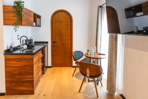 a kitchen with a sink and a table with a chair at Casa Castillo in Mexico City