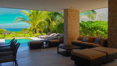 a living room with a view of the ocean at Donoussa Beach home in Uaymitun