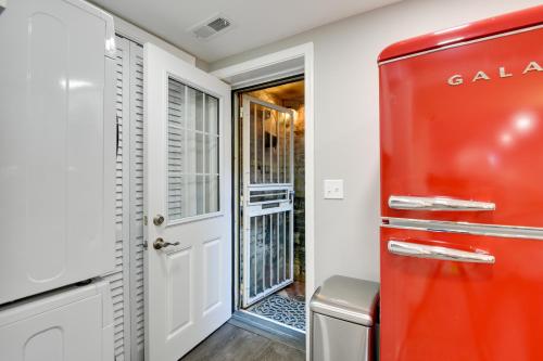 einen roten Kühlschrank in einem Zimmer mit Tür in der Unterkunft Convenient Washington, DC, Studio Near Metro Stop! in Washington
