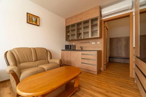 a living room with a table and a couch at Winifera Penzion in Pavlov