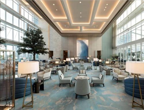 a lobby with chairs and tables in a building at 1 BEDROOM ADDRESS BEACH FRONT JBR in Dubai