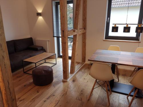a living room with a table and a couch at Filder-Appartements in Filderstadt