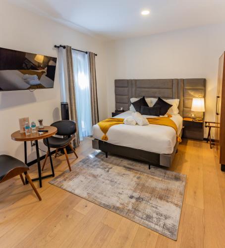 a bedroom with a large bed and a table and chairs at Casa Castillo in Mexico City