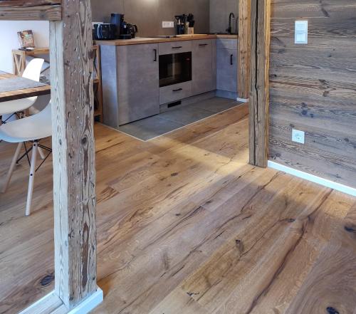 a kitchen and dining room with wooden flooring at Filder-Appartements in Filderstadt