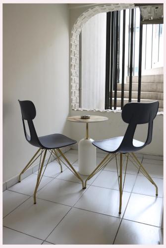 two chairs and a table in a room at Dab Hotel Ulus in Ankara