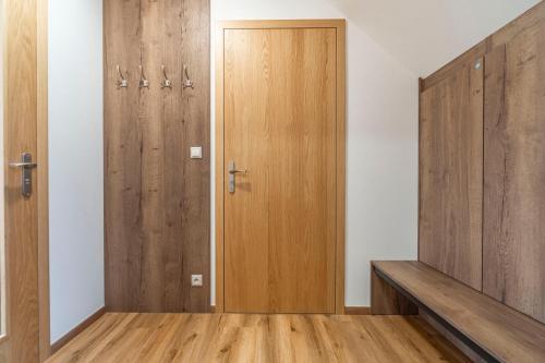 a locker room with wooden doors and wooden floors at Winifera Penzion in Pavlov