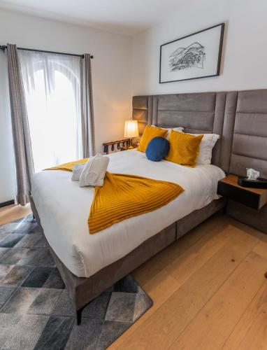 a bedroom with a large bed with yellow pillows at Casa Castillo in Mexico City