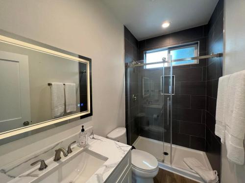 a bathroom with a sink and a toilet and a shower at Beach Apartment in Huntington Beach