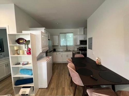 a kitchen and dining room with a table and chairs at Beach Apartment in Huntington Beach