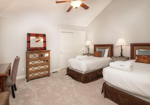 a bedroom with two beds and a desk and a ceiling fan at Castle Peak Close in Edwards