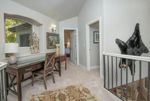 a dining room with a table and a desk at Castle Peak Close in Edwards