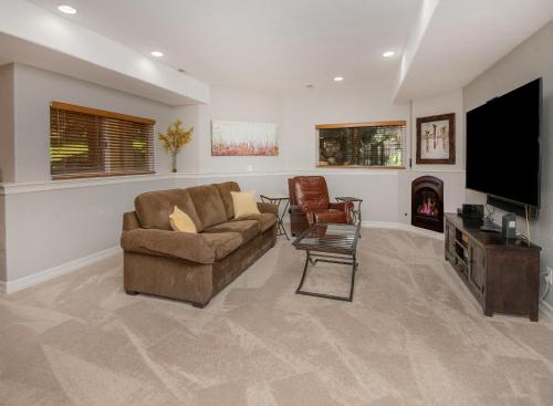 a living room with a couch and a flat screen tv at Castle Peak Close in Edwards