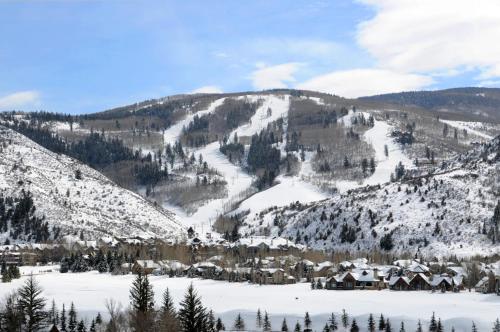 a snow covered mountain with a village in the foreground at Castle Peak Close in Edwards
