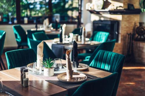 a restaurant with wooden tables and green chairs at CONTELE VLADIMIR in Bran