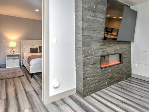 a bedroom with a fireplace in a room with a bed at Fall Ridge in Vail
