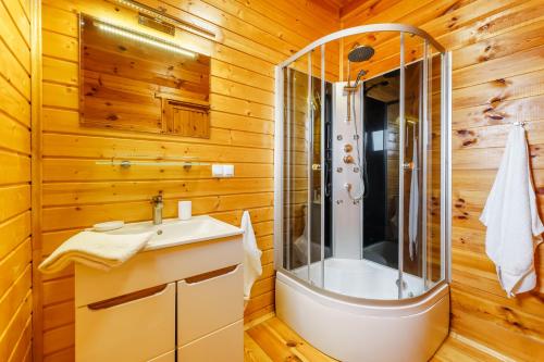 a bathroom with a shower and a sink at Nadmorska House in Grzybowo